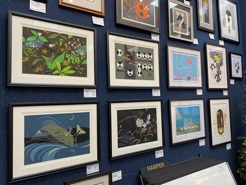 view of framed prints hung on a wall